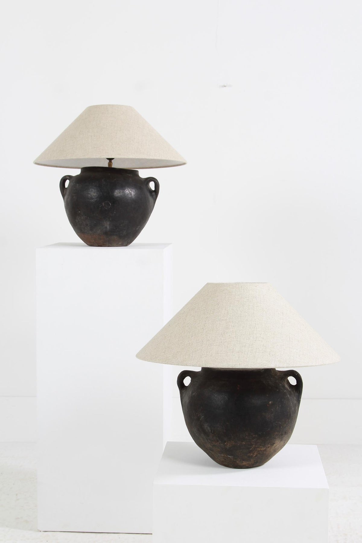 PAIR OF ANTIQUE MEDITERRANEAN BLACK BURNISHED POT LAMPS WITH LINEN  SHADES