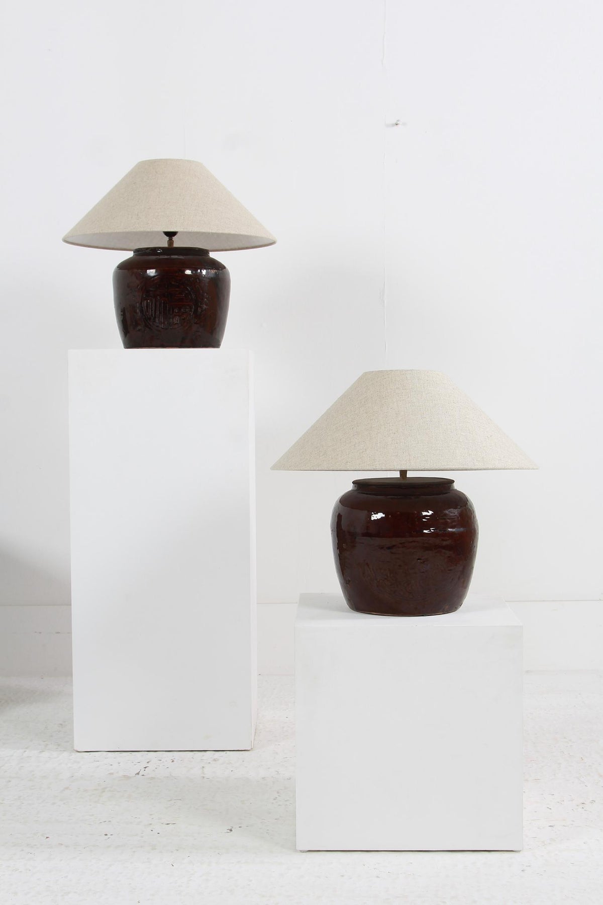 COLLECTION OF TWO  BROWN GLAZED POTTERY TABLE LAMPS WITH NATURAL EMPIRE LINEN SHADES