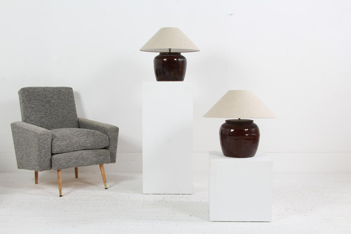 COLLECTION OF TWO  BROWN GLAZED POTTERY TABLE LAMPS WITH NATURAL EMPIRE LINEN SHADES