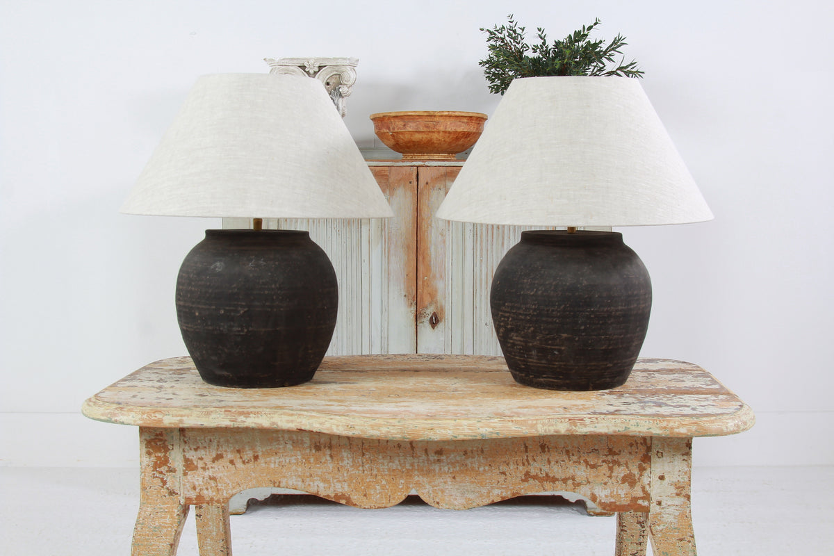 NEAR PAIR OF CHINESE BLACK POTTERY TABLE  LAMPS WITH NATURAL LINEN EMPIRE SHADES