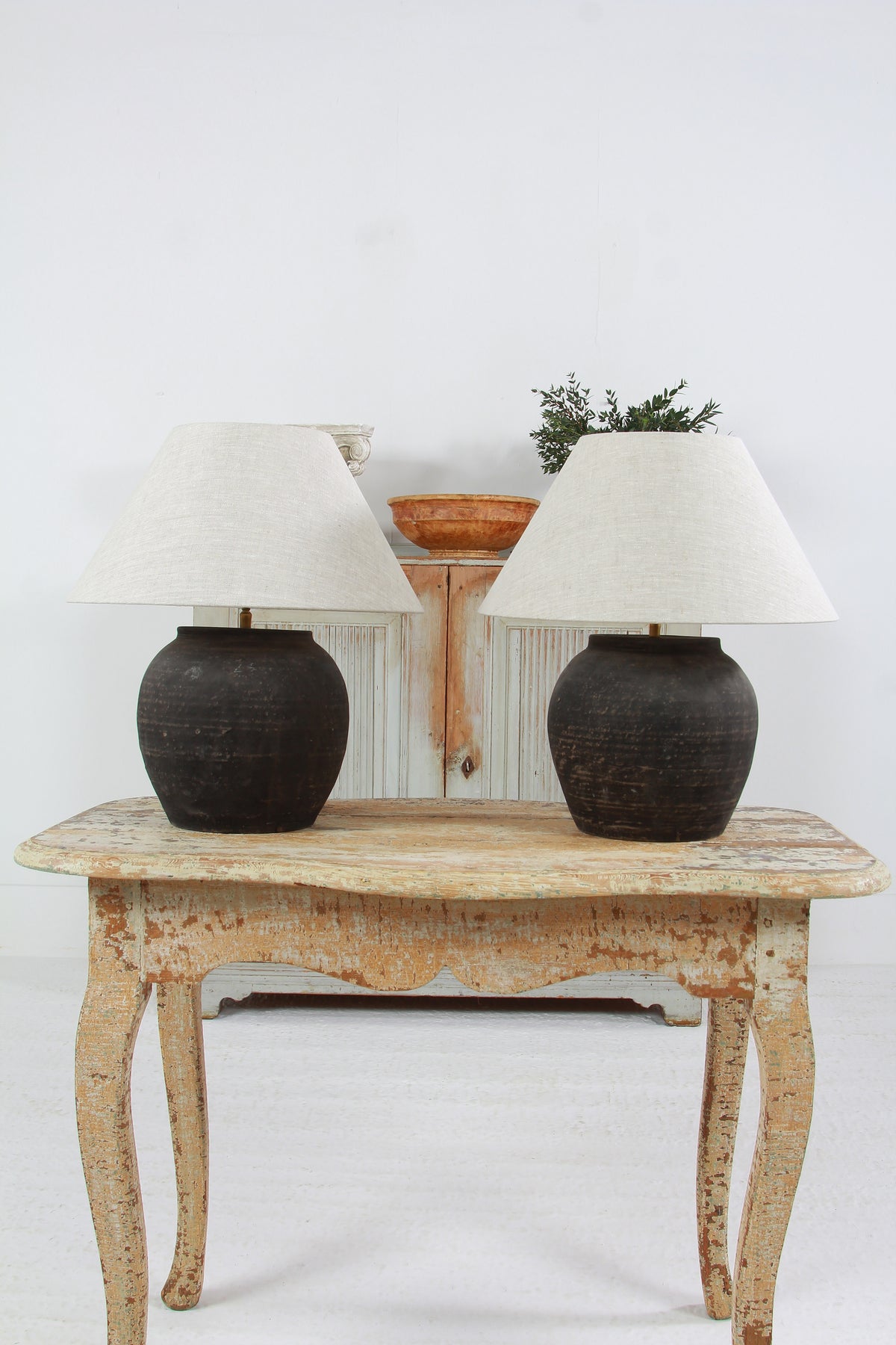 NEAR PAIR OF CHINESE BLACK POTTERY TABLE  LAMPS WITH NATURAL LINEN EMPIRE SHADES