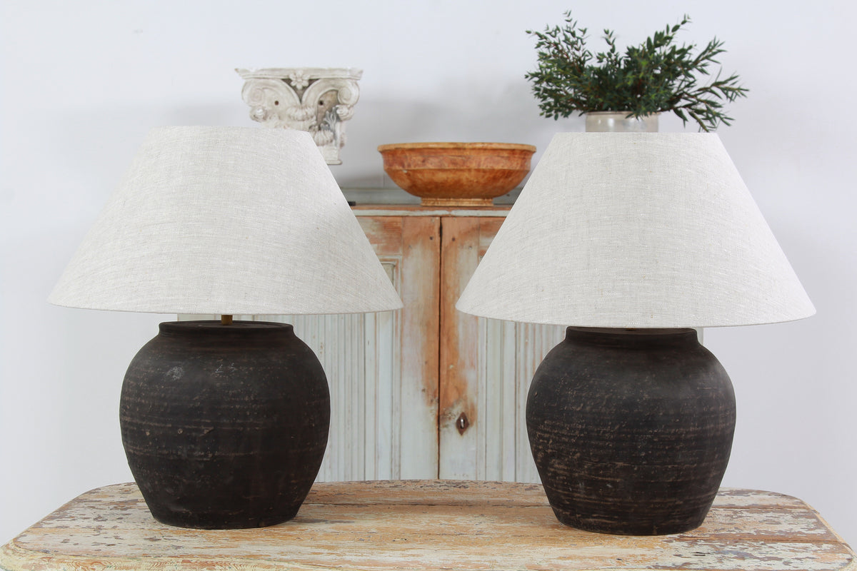 NEAR PAIR OF CHINESE BLACK POTTERY TABLE  LAMPS WITH NATURAL LINEN EMPIRE SHADES