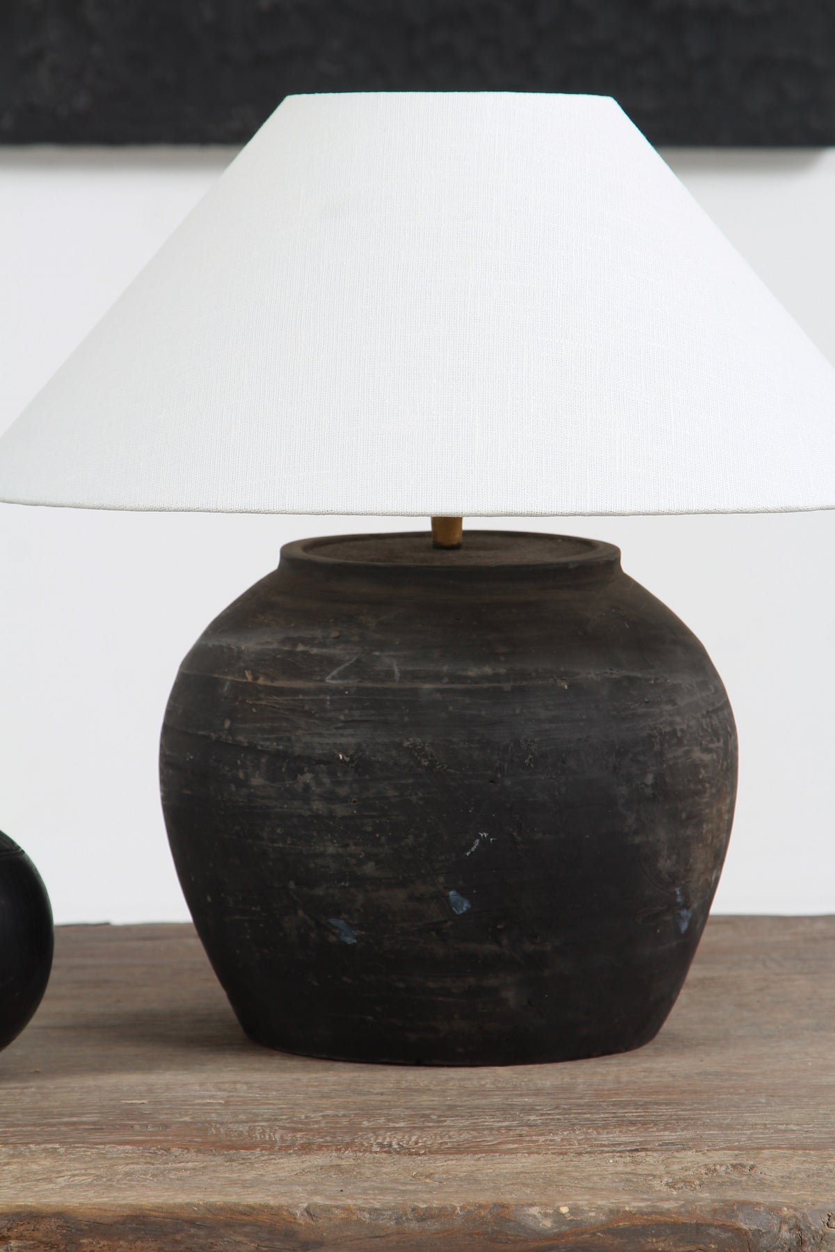BLACK UNGLAZED POTTERY TABLE LAMP WITH WHITE EMPIRE LINEN SHADE