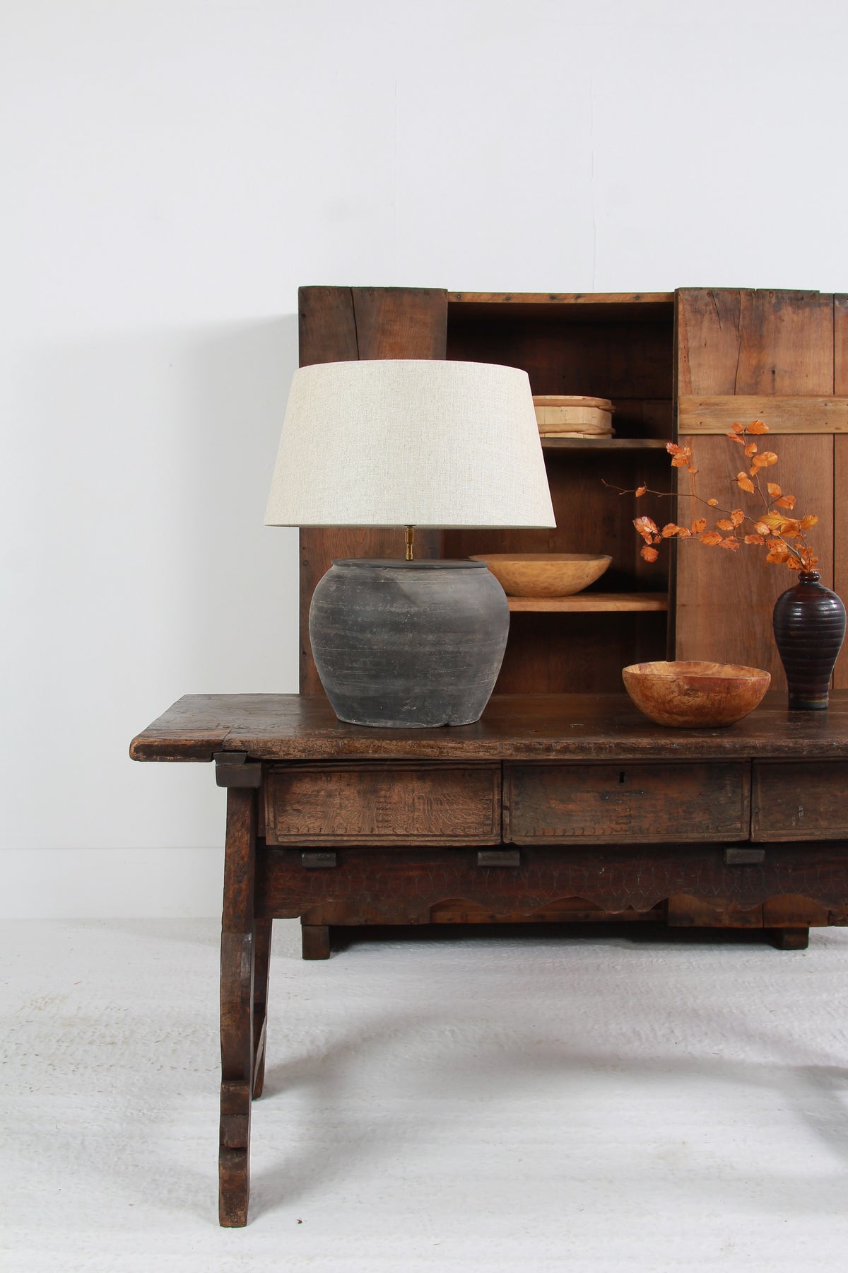 ANTIQUE BLACK UNGLAZED TABLE LAMP WITH NATURAL LINEN DRUM SHADE