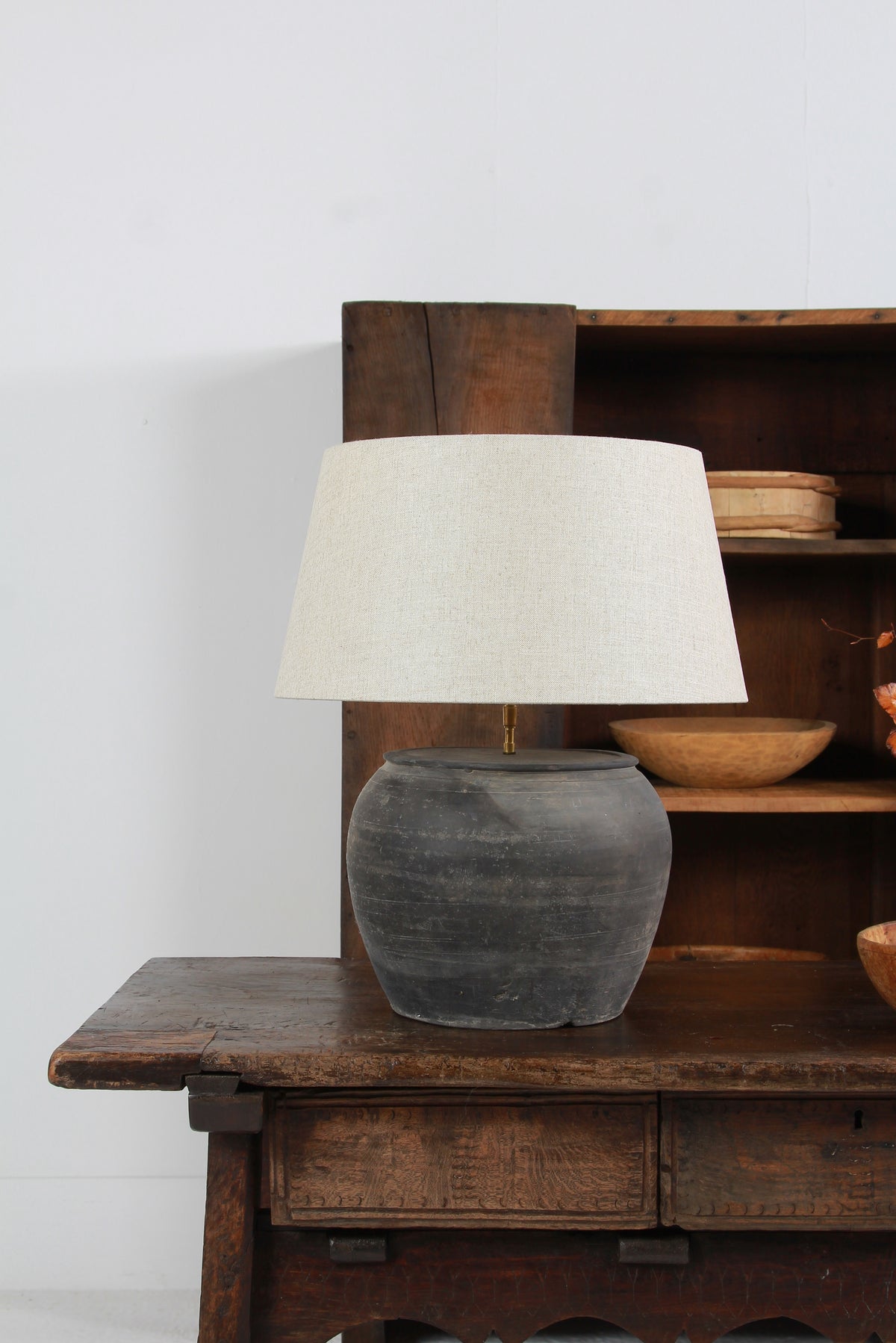 ANTIQUE BLACK UNGLAZED TABLE LAMP WITH NATURAL LINEN DRUM SHADE