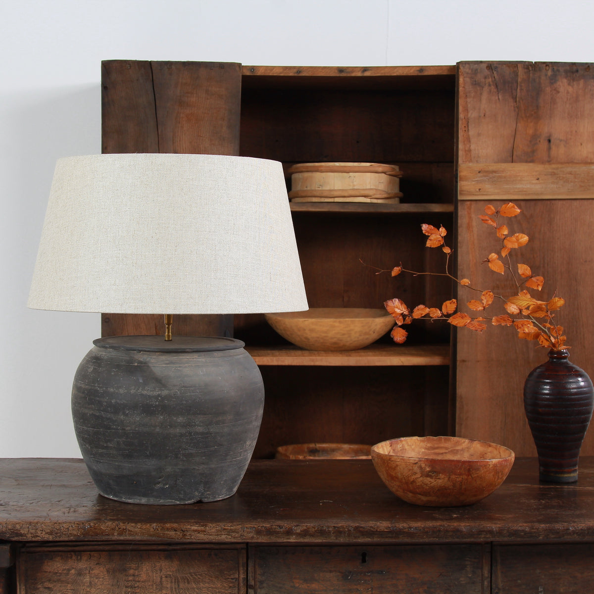 ANTIQUE BLACK UNGLAZED TABLE LAMP WITH NATURAL LINEN DRUM SHADE