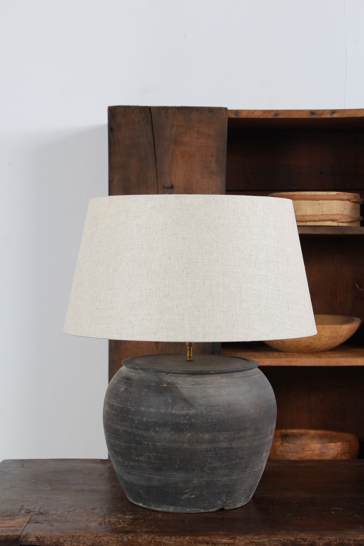 ANTIQUE BLACK UNGLAZED TABLE LAMP WITH NATURAL LINEN DRUM SHADE