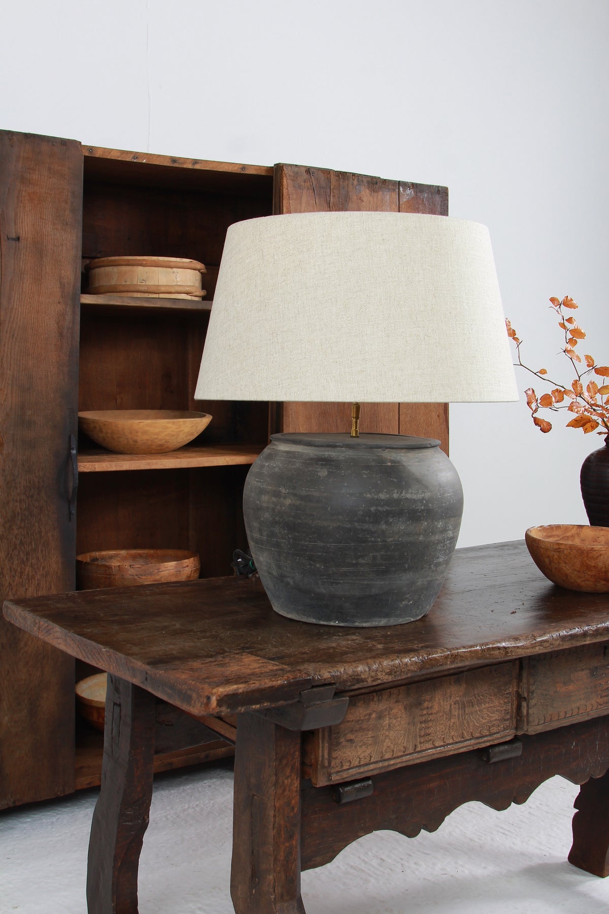 ANTIQUE BLACK UNGLAZED TABLE LAMP WITH NATURAL LINEN DRUM SHADE