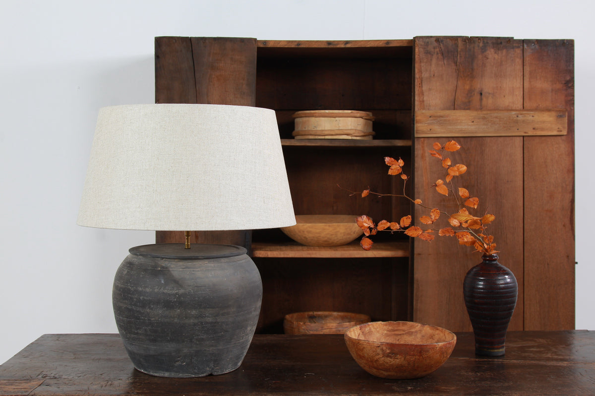 ANTIQUE BLACK UNGLAZED TABLE LAMP WITH NATURAL LINEN DRUM SHADE