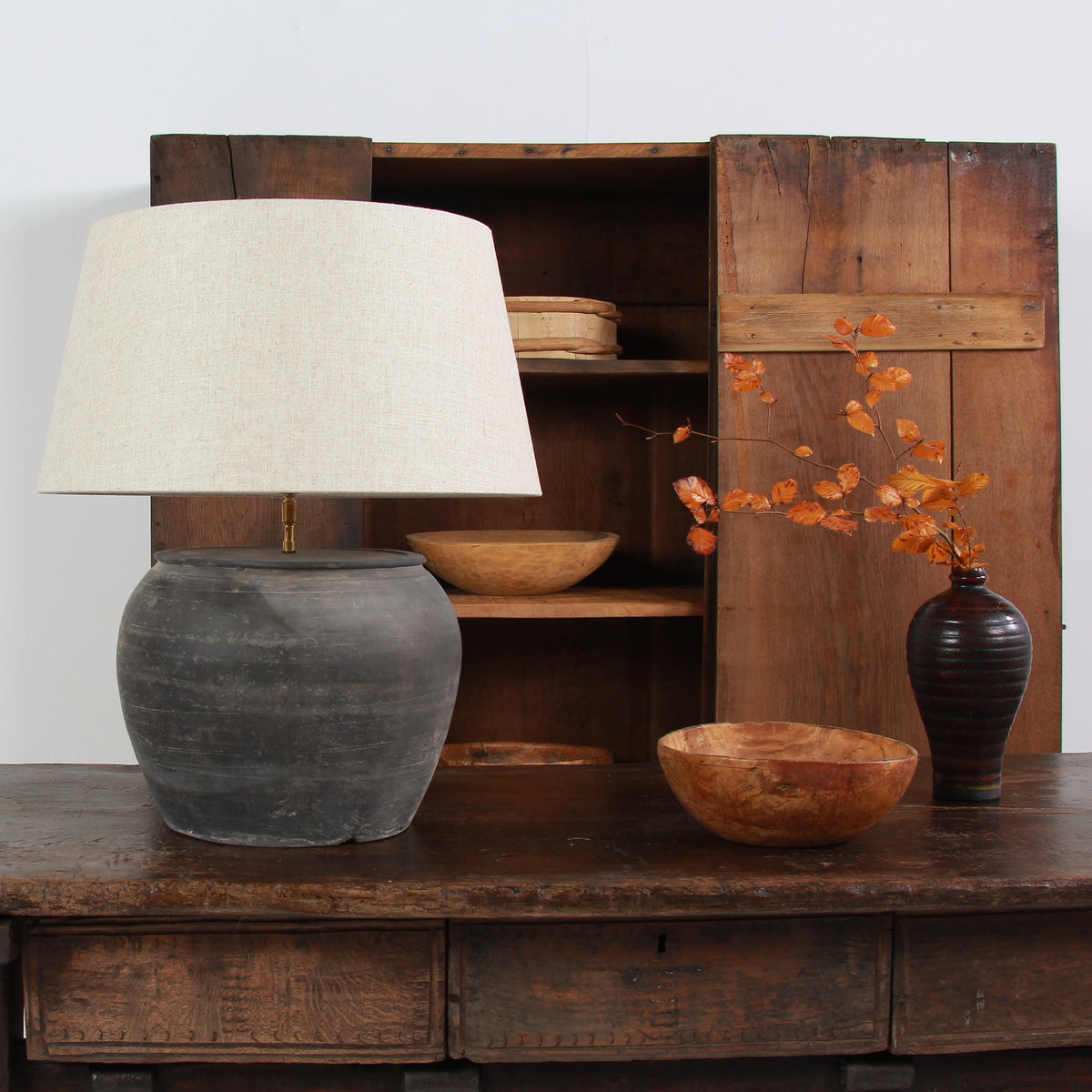 ANTIQUE BLACK UNGLAZED TABLE LAMP WITH NATURAL LINEN DRUM SHADE
