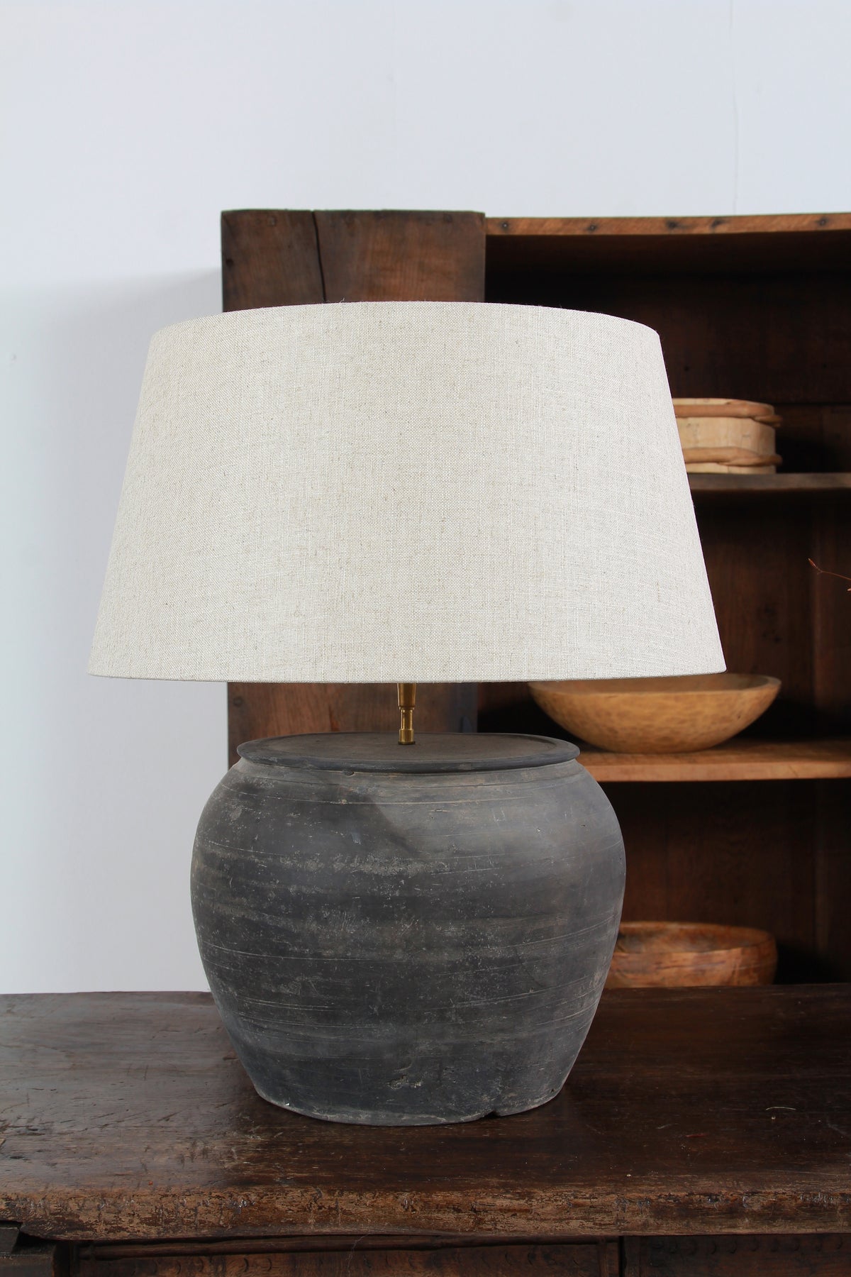ANTIQUE BLACK UNGLAZED TABLE LAMP WITH NATURAL LINEN DRUM SHADE