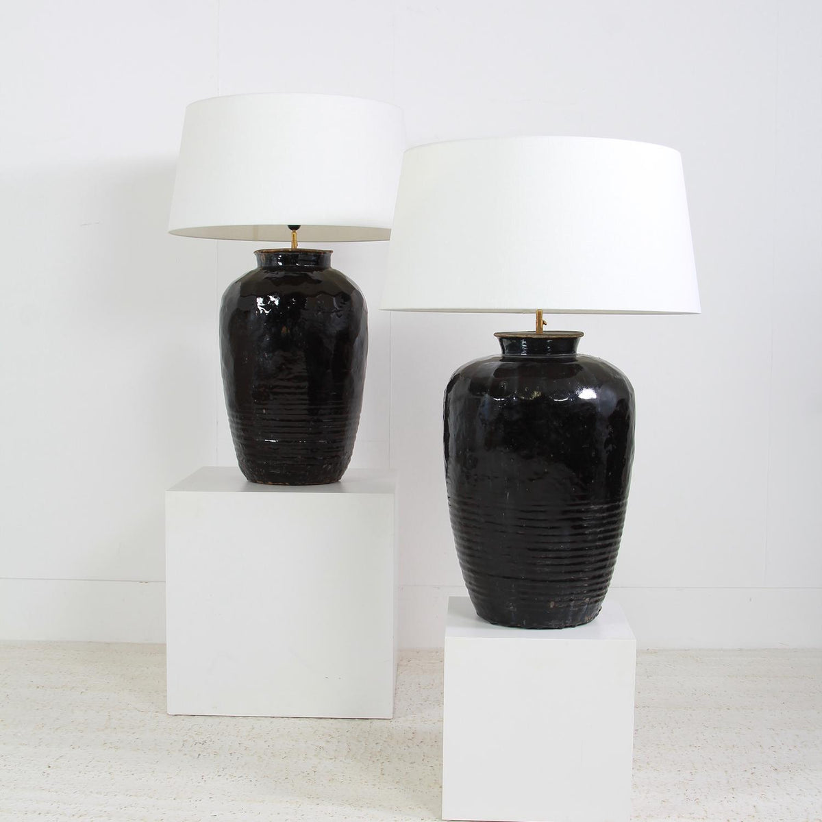 Monumental  ANTIQUE BLACK GLAZED POTTERY LAMPS WITH WHITE DRUM LINEN SHADES