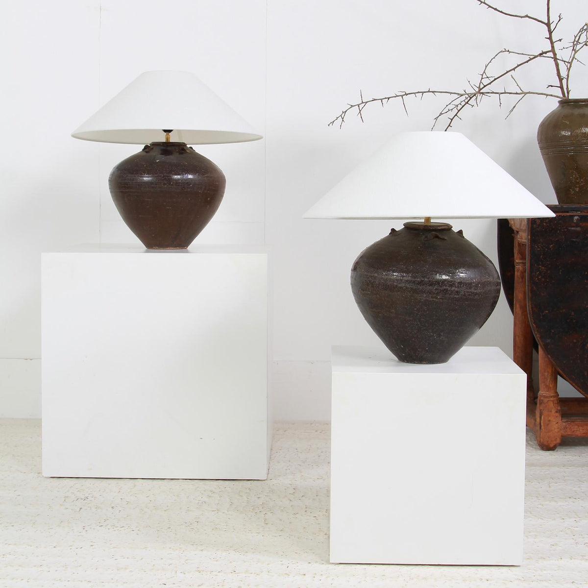 ANTIQUE CHINESE CERAMIC WINE POTS CONVERTED INTO LAMPS WITH WHITE LINEN SHADE