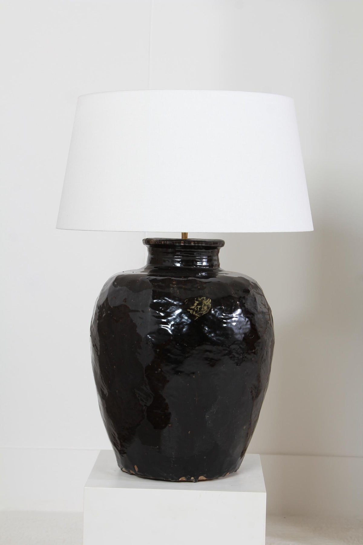 MONUMENTAL ANTIQUE BLACK GLAZED POTTERY LAMP WITH WHITE DRUM LINEN SHADE