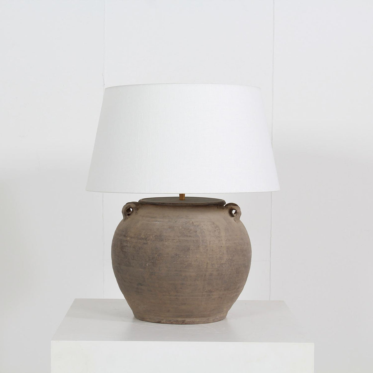 TERRACOTTA UNGLAZED POTTERY LAMP WITH WHITE  LINEN DRUM SHADE