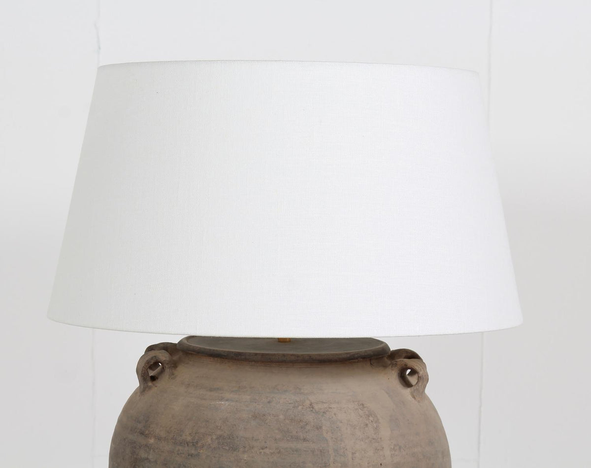 TERRACOTTA UNGLAZED POTTERY LAMP WITH WHITE  LINEN DRUM SHADE