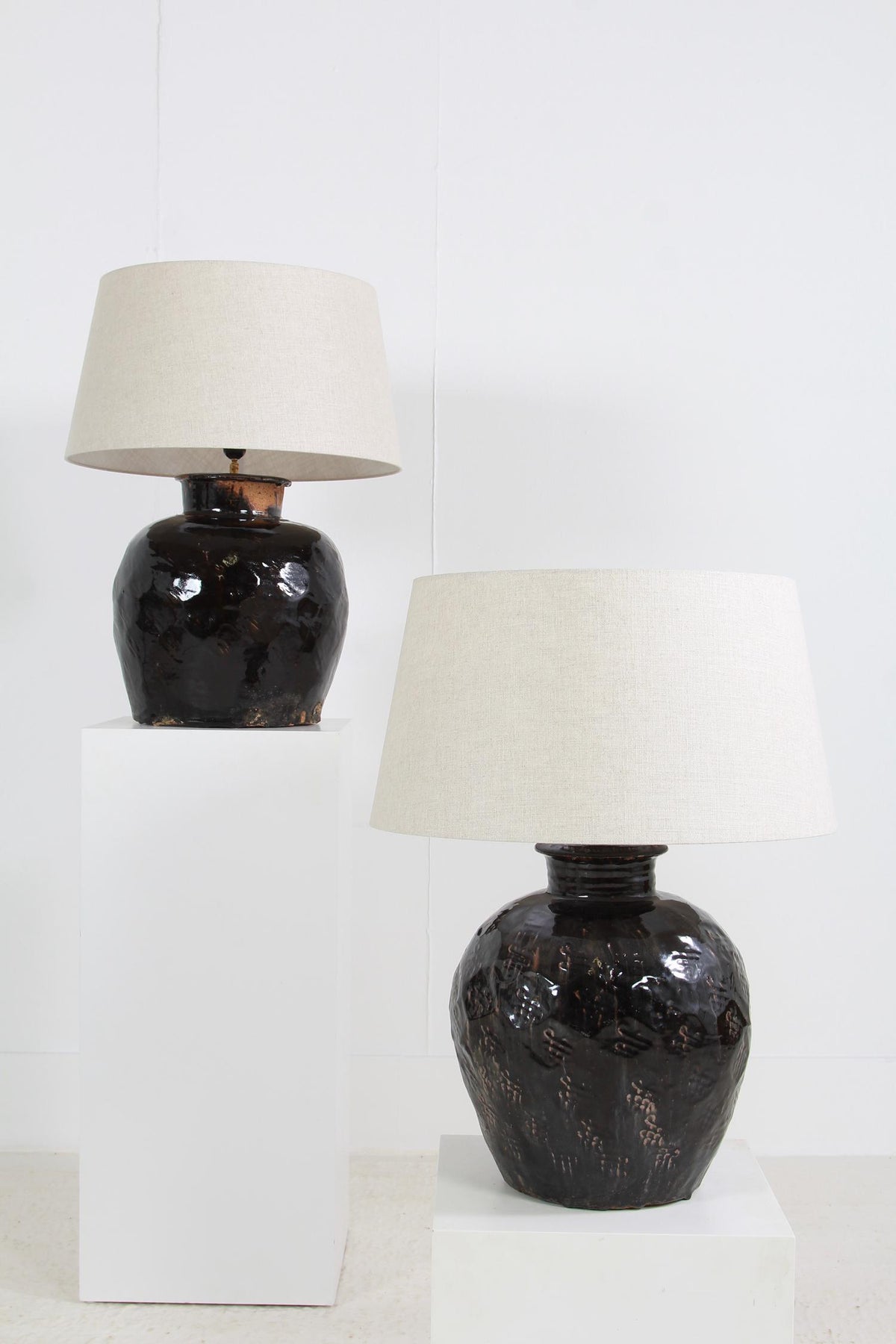 ANTIQUE BLACK GLAZED POTTERY LAMPS WITH WHITE DRUM LINEN SHADES