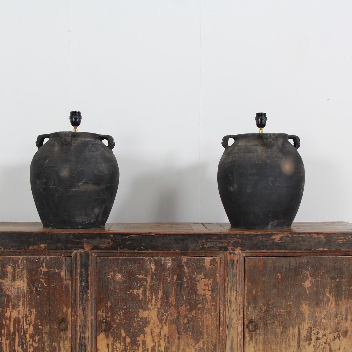 PAIR OF LARGE BLACK  POTTERY LAMPS WITH WHITE LINEN SHADES